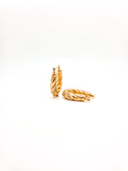 Gold hoop earrings on a white background