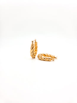 Gold hoop earrings on a white background