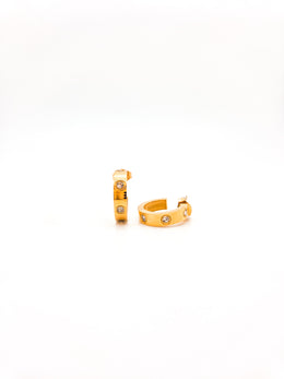 Gold hoop earrings with small stones on a white background