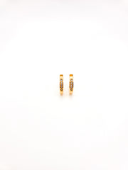 Gold hoop earrings with small diamonds on a white background