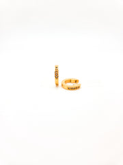 Gold hoop earrings on a white background