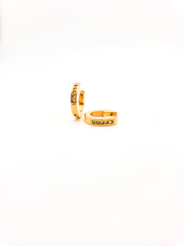 Gold hoop earrings with small stones on a white background