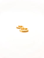 Gold ring with small stones on a white background