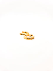 Gold ring with small stones on a white background